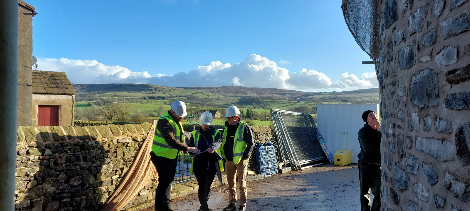 Cornerstone team in hard hats and hi-vis on a heritage site in the Lancashire countryside