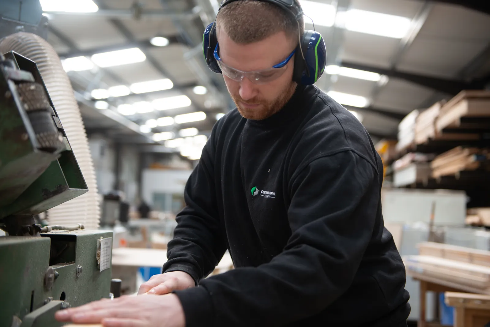 Machining timber, glasses and ear defenders on